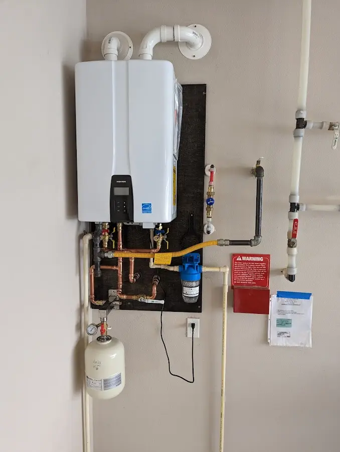 Professional plumber installing copper piping in a Oconomowoc home